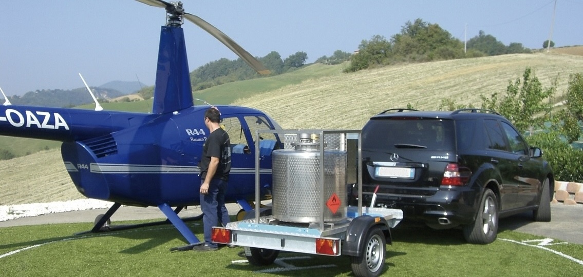 Trailer-mounted aviation refueling unit servicing a helicopter