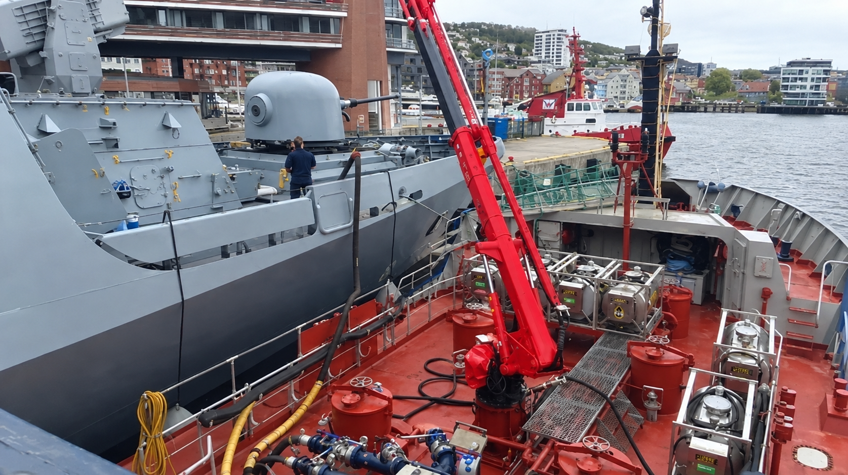 Vessel refueling operation alongside a naval ship