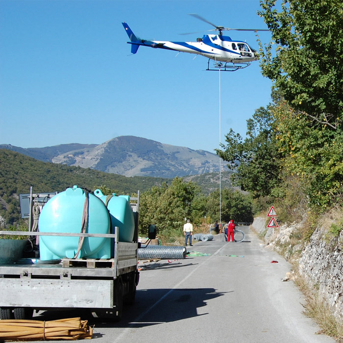Water tanks loaded for helicopter airlift to a remote mountain site