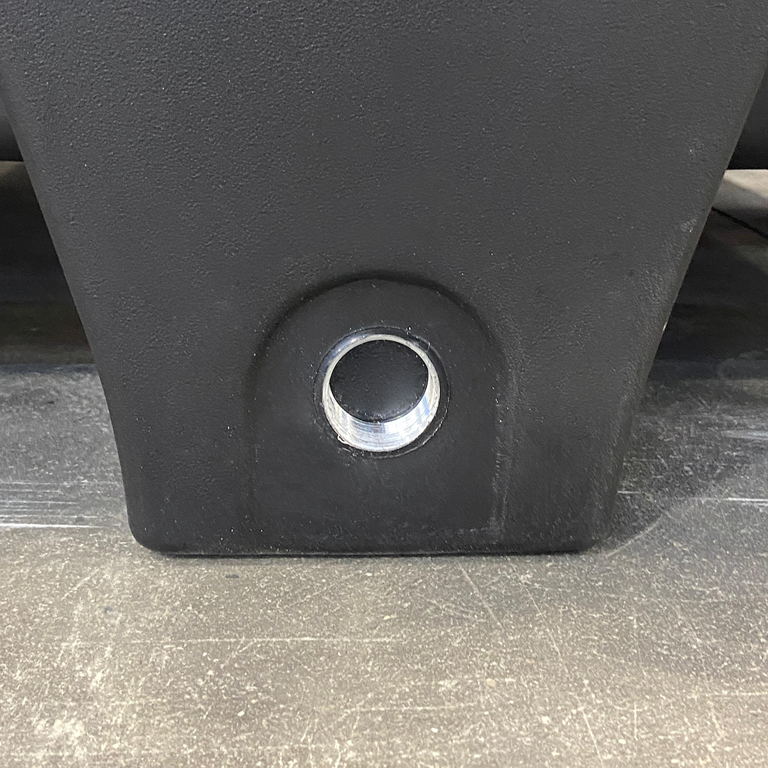 Detail of the threaded drain plug on a polyethylene containment sump