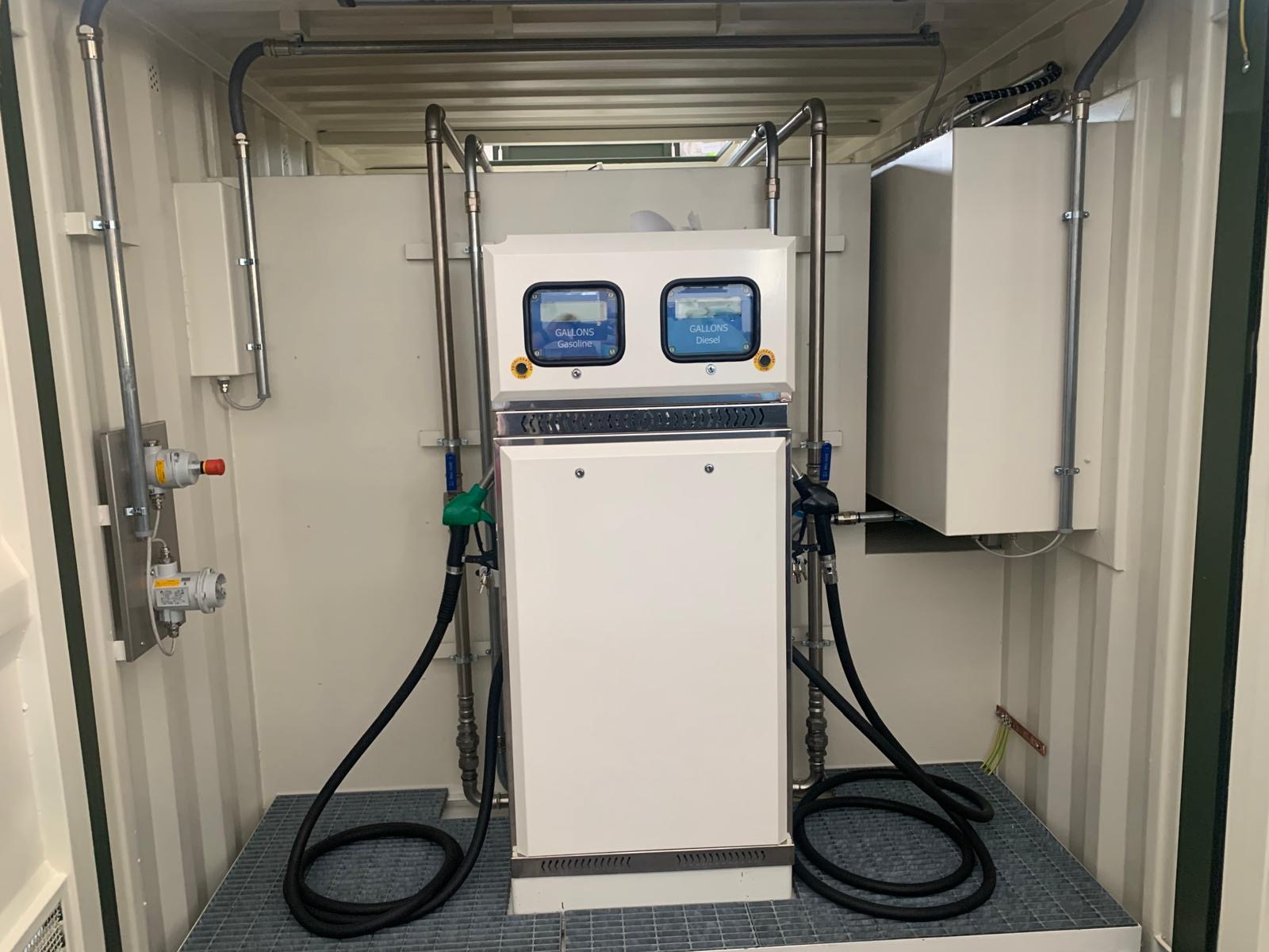 Dual-fuel dispensing station with gasoline and diesel nozzles inside an enclosure